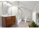 Neutral bathroom featuring a white vanity, a mirror and a shower with a sliding door at 4224 River Rd, Columbus, IN 47203