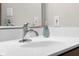 Close up of sink with chrome faucet and mirror in modern bathroom at 4224 River Rd, Columbus, IN 47203