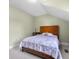 Cozy bedroom with a wooden framed bed and light green walls at 4224 River Rd, Columbus, IN 47203