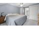 Comfortable bedroom with a queen-sized bed, ceiling fan, and soft blue-gray walls at 4224 River Rd, Columbus, IN 47203