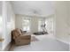 Bright bonus room with large windows, neutral walls and carpet, plus a treadmill and sofa at 4224 River Rd, Columbus, IN 47203