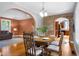Open concept dining room with brick archway, wood floors, and views to the living room at 4224 River Rd, Columbus, IN 47203