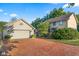 Lovely two-story house with a detached garage, brick driveway, and lush greenery at 4224 River Rd, Columbus, IN 47203