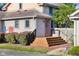 Home exterior featuring orange front and side doors, brown steps, and well-maintained landscaping at 4224 River Rd, Columbus, IN 47203