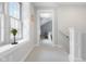 Bright hallway with large windows and soft, neutral-colored walls leads to the bedroom at 4224 River Rd, Columbus, IN 47203