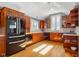 Well-lit kitchen with wood cabinets, stainless steel appliances, and a ceiling fan at 4224 River Rd, Columbus, IN 47203