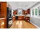 Spacious kitchen with wood cabinets, stainless steel appliances, and bright natural light at 4224 River Rd, Columbus, IN 47203