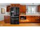 Close-up of kitchen with wood cabinets, stainless appliances, and tile backsplash at 4224 River Rd, Columbus, IN 47203