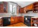 Kitchen with stainless appliances, black sink, quartz countertops, and wood cabinets at 4224 River Rd, Columbus, IN 47203