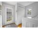 Laundry room featuring washer, dryer, utility closet, window, and access to back yard at 4224 River Rd, Columbus, IN 47203