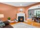 Welcoming living room featuring a fireplace, hardwood floors, and seamless flow to the dining area at 4224 River Rd, Columbus, IN 47203