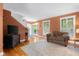 Cozy living room with hardwood floors, a leather couch, and bright natural light at 4224 River Rd, Columbus, IN 47203