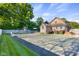 View of the backyard with a full tennis court, pool, deck and home at 4224 River Rd, Columbus, IN 47203