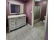 Traditional bathroom with a single sink vanity, tile flooring and bathtub with glass doors at 4501 N Wheeling Ave # 5E4, Muncie, IN 47304