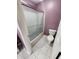 Cozy bathroom with a glass-enclosed shower, tiled floor, and a standard toilet at 4501 N Wheeling Ave # 5E4, Muncie, IN 47304