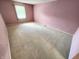 Bedroom with plush carpeting, natural light, and spacious layout at 4501 N Wheeling Ave # 5E4, Muncie, IN 47304