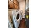 Laundry room with updated washer and dryer and classic wood cabinetry at 4501 N Wheeling Ave # 5E4, Muncie, IN 47304
