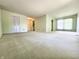 Spacious, carpeted living room with large window and a closet at 4501 N Wheeling Ave # 5E4, Muncie, IN 47304