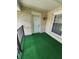 Cozy outdoor patio area with green turf carpet at 4501 N Wheeling Ave # 5E4, Muncie, IN 47304