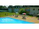Community pool with lounge chairs and picnic tables at 4501 N Wheeling Ave # 5E4, Muncie, IN 47304