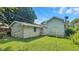 View of the backyard with detached garage and additional building with mature lawn at 4708 Fletcher Ave, Indianapolis, IN 46203
