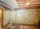 Unfinished basement with concrete block walls, utility box and exposed ceiling features at 4708 Fletcher Ave, Indianapolis, IN 46203