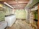 View of laundry area in unfinished basement, concrete walls and open ceiling at 4708 Fletcher Ave, Indianapolis, IN 46203