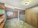 Unfinished basement space with wood paneled walls, utility pole and glass-blocked nook at 4708 Fletcher Ave, Indianapolis, IN 46203