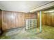Spacious basement with wood paneling, a glass block feature, and concrete flooring at 4708 Fletcher Ave, Indianapolis, IN 46203