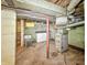 View of laundry area in unfinished basement, concrete walls and open ceiling at 4708 Fletcher Ave, Indianapolis, IN 46203