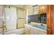 Bathroom features a shower/tub combo, vanity with a sink, and tile details at 4708 Fletcher Ave, Indianapolis, IN 46203