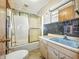Bathroom features a shower/tub combo, toilet, and vanity with a blue sink, offering basic amenities at 4708 Fletcher Ave, Indianapolis, IN 46203
