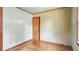 Bedroom featuring wood floor, closet door, and patterned wall paper at 4708 Fletcher Ave, Indianapolis, IN 46203