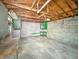 Unfinished garage with concrete block walls, high wood truss ceiling, and a concrete floor at 4708 Fletcher Ave, Indianapolis, IN 46203