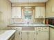 Kitchen features a window, sink, and upper and lower cabinets providing storage at 4708 Fletcher Ave, Indianapolis, IN 46203
