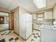 Kitchen featuring a refrigerator, stove, and a view of the entryway to other parts of the house at 4708 Fletcher Ave, Indianapolis, IN 46203