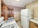 Kitchen featuring a refrigerator, stove, and a view of the entryway to other parts of the house at 4708 Fletcher Ave, Indianapolis, IN 46203