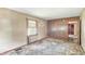 This is a view of the living room with a window and wood paneled wall at 4708 Fletcher Ave, Indianapolis, IN 46203