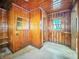 Room featuring full wood paneling, window, and mirror at 4708 Fletcher Ave, Indianapolis, IN 46203