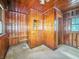 View of room featuring full wood paneling with window, mirror and shelving at 4708 Fletcher Ave, Indianapolis, IN 46203