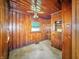 Cozy room featuring wood paneling on walls and ceiling, a window, and a ceiling fan at 4708 Fletcher Ave, Indianapolis, IN 46203