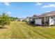 Expansive backyard with lush green grass, manicured landscaping, and a patio area for outdoor enjoyment at 4905 Lilium Dr, Plainfield, IN 46168