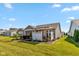 Serene backyard featuring a patio, a screened-in porch, and well-maintained landscaping for outdoor living at 4905 Lilium Dr, Plainfield, IN 46168