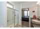 Bathroom with a glass-enclosed shower and a view into the bedroom at 4905 Lilium Dr, Plainfield, IN 46168