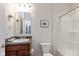 Well-lit bathroom with shower-tub, decorative granite counter and framed mirror at 4905 Lilium Dr, Plainfield, IN 46168