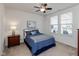 Comfortable bedroom with a queen bed, ceiling fan, and natural light at 4905 Lilium Dr, Plainfield, IN 46168