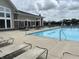Community pool with lounge chairs and tables and building in the background at 4905 Lilium Dr, Plainfield, IN 46168