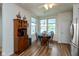 Bright dining area with wood floors, a pendant light, and a wooden hutch at 4905 Lilium Dr, Plainfield, IN 46168