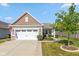 Charming single-story home with a well-manicured lawn and a two-car garage on a beautiful, sunny day at 4905 Lilium Dr, Plainfield, IN 46168