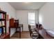 Bright home office with hardwood floors, large desk, and built-in bookcase at 4905 Lilium Dr, Plainfield, IN 46168